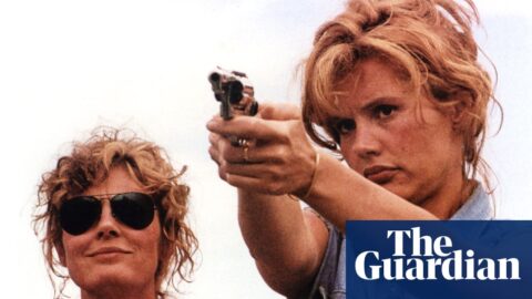 Thelma and Louise outdoors, with Geena Davis aiming a handgun as Susan Sarandon watches