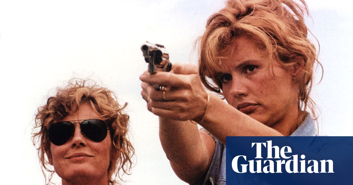 Thelma and Louise outdoors, with Geena Davis aiming a handgun as Susan Sarandon watches