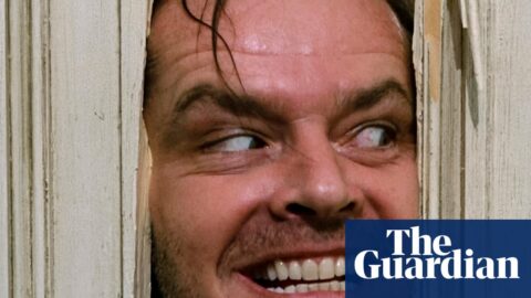 Jack Nicholson grins manically through a hole he hacked in a wooden door