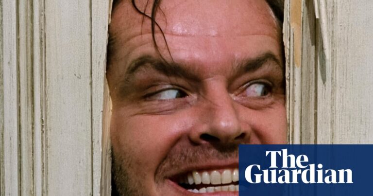 Jack Nicholson grins manically through a hole he hacked in a wooden door