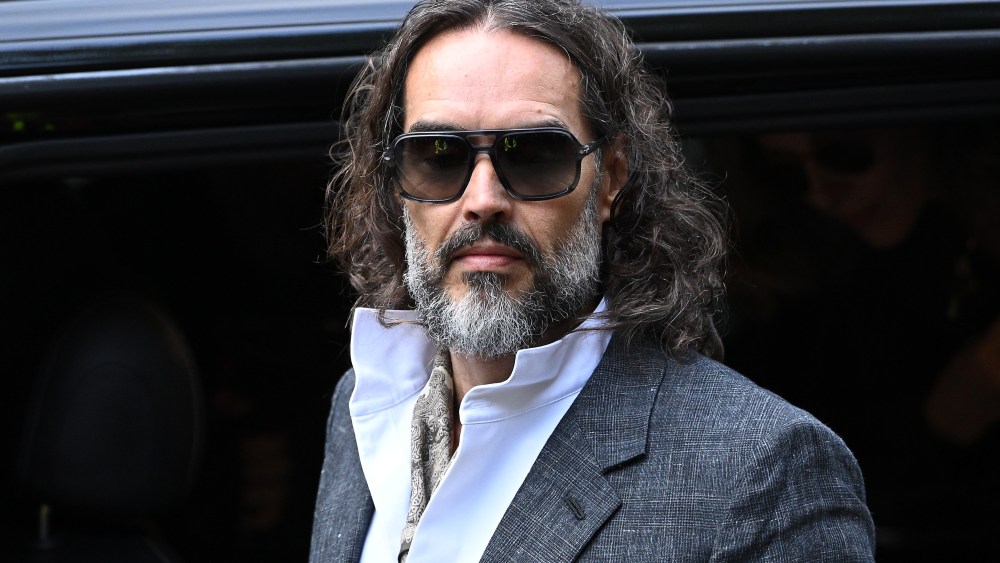 LONDON, ENGLAND - OCTOBER 12: Russell Brand arrives at court ahead of his trial, where he faces rape and sexual assault charges at Southwark Crown Court on October 12, 2026 in London, England. Russell Brand has been charged with three counts of rape, three counts of sexual assault and one count of indecent assault. He has denied all charges (Photo by Leon Neal/Getty Images)